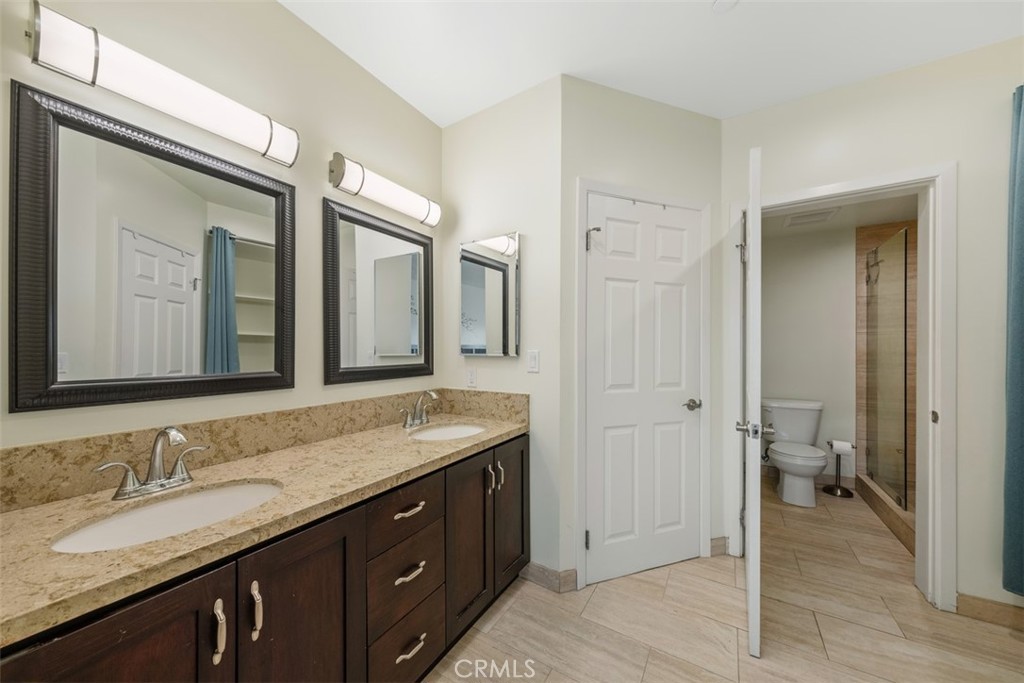 900 Dwight Avenue, Unit 108 Compton, CA 90220 - Photo 38 of 49 a bathroom with a granite countertop sink double and mirror