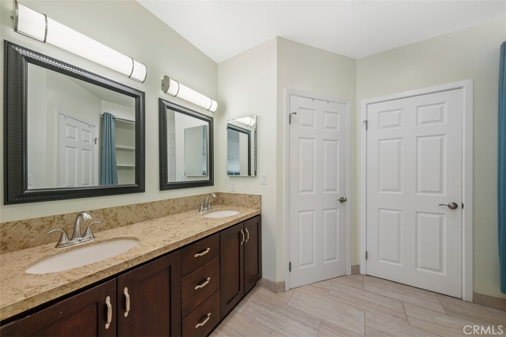 900 Dwight Avenue, Unit 108 Compton, CA 90220 - Photo 39 of 49 a bathroom with a granite countertop sink and a mirror