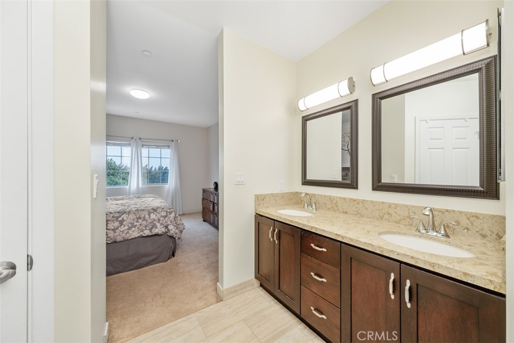 900 Dwight Avenue, Unit 108 Compton, CA 90220 - Photo 40 of 49 a spacious bathroom with a granite countertop sink and a mirror