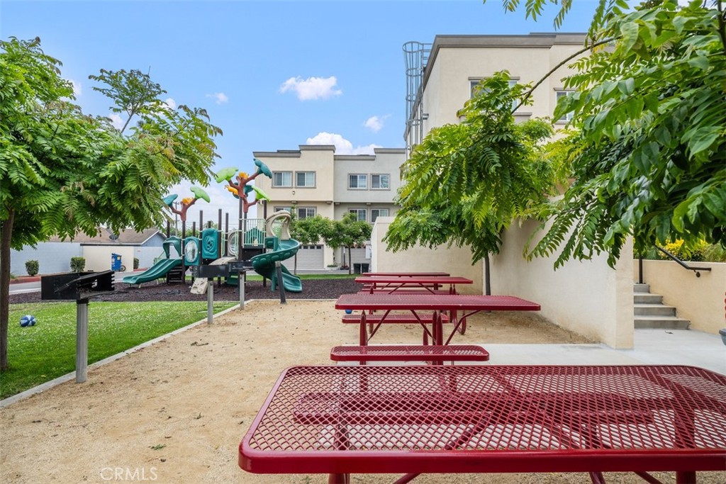 900 Dwight Avenue, Unit 108 Compton, CA 90220 - Photo 45 of 49 a swimming pool with a bench and trees