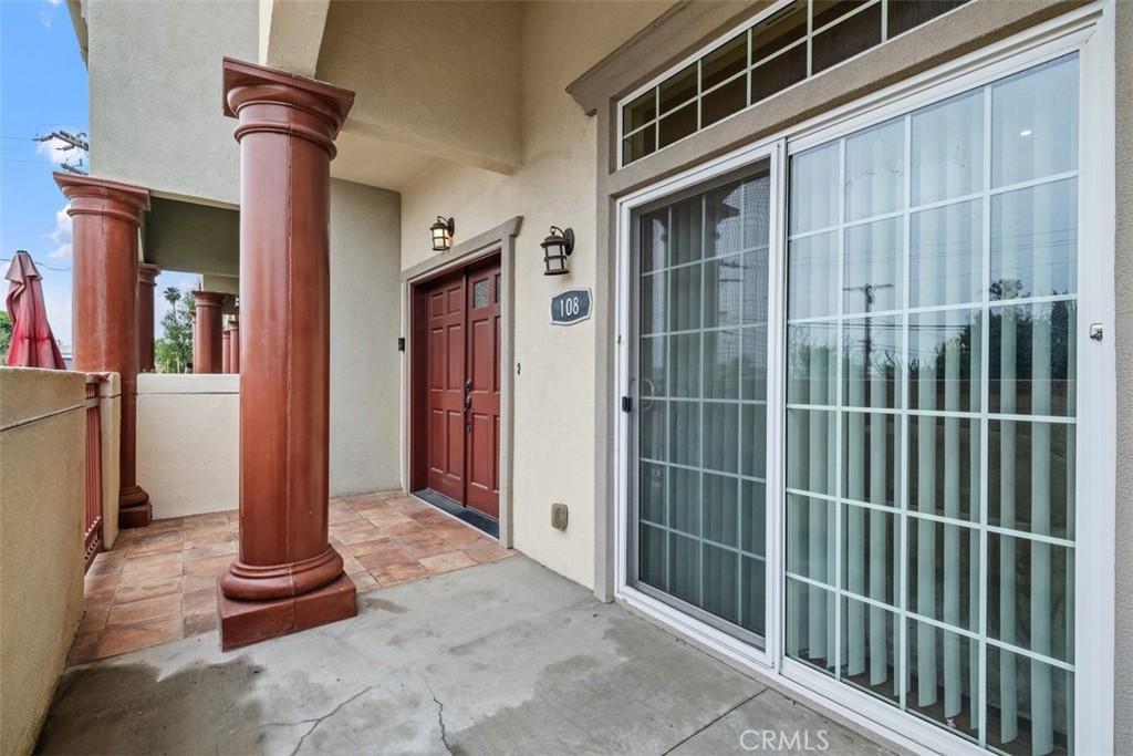 900 Dwight Avenue, Unit 108 Compton, CA 90220 - Photo 6 of 49 a front view of a house with a garden