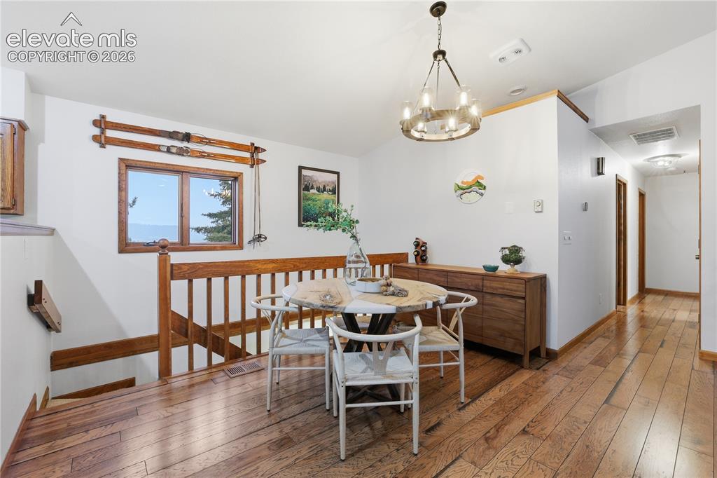 18190 Forest View Road Monument, CO 80132 - Photo 4 of 50 a view of a dining room with furniture wooden floor and front door