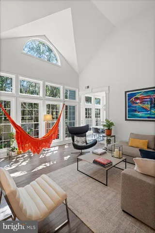 a kitchen with stainless steel appliances granite countertop a refrigerator a sink dishwasher a stove with wooden cabinets and floor