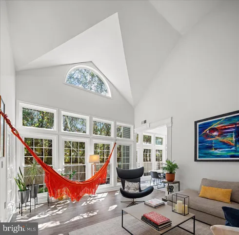 a kitchen with stainless steel appliances granite countertop a stove a refrigerator a sink a dining table and chairs