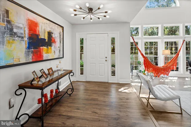 a living room with furniture a floor to ceiling windows and a flat screen tv
