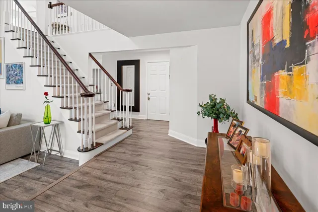 a living room with furniture a flat screen tv and a floor to ceiling window