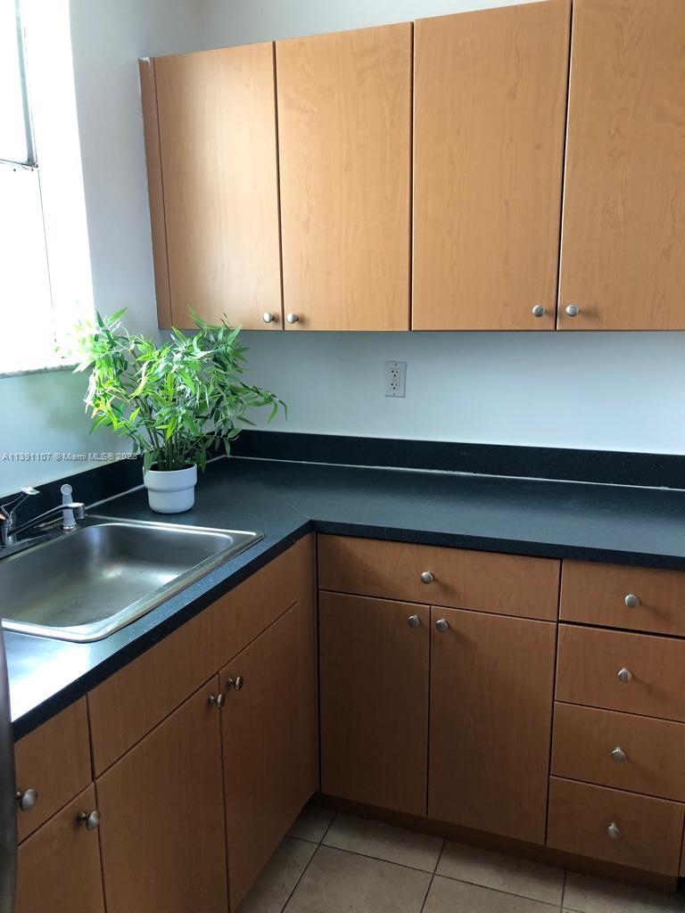 Shorecrest Miami, FL 33138 - Photo 2 of 18 a kitchen with a sink and cabinets