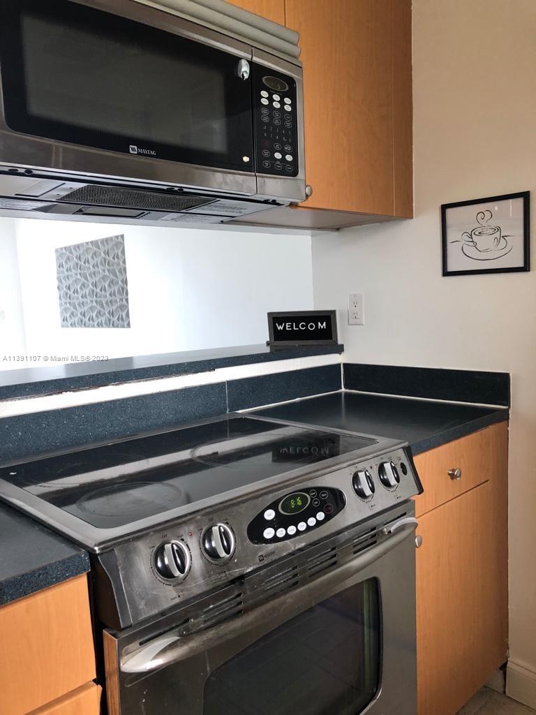 Shorecrest Miami, FL 33138 - Photo 3 of 18 a stove top oven sitting inside of a kitchen