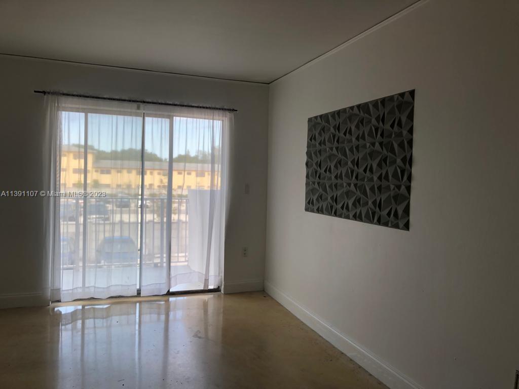 Shorecrest Miami, FL 33138 - Photo 5 of 18 an empty room with wooden floor and windows