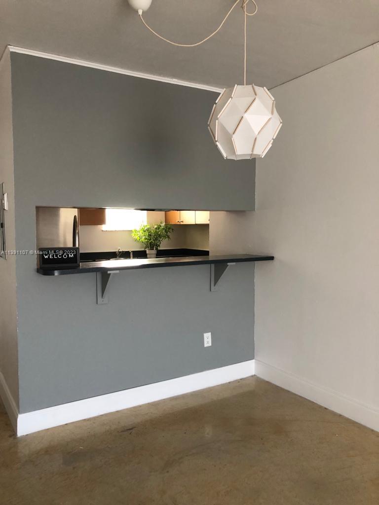 Shorecrest Miami, FL 33138 - Photo 6 of 18 a view of a hallway with a chandelier