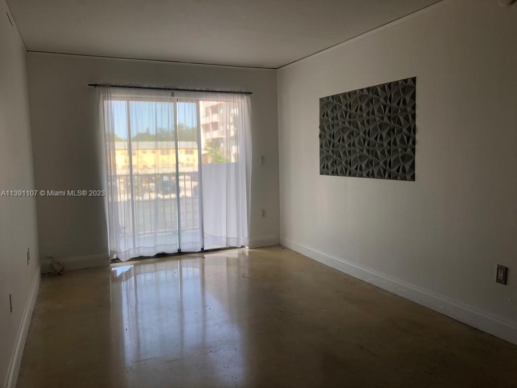 Shorecrest Miami, FL 33138 - Photo 8 of 18 an empty room with wooden floor and windows