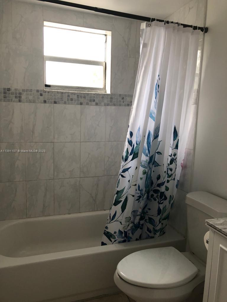 Shorecrest Miami, FL 33138 - Photo 9 of 18 a white toilet sitting next to a bath tub