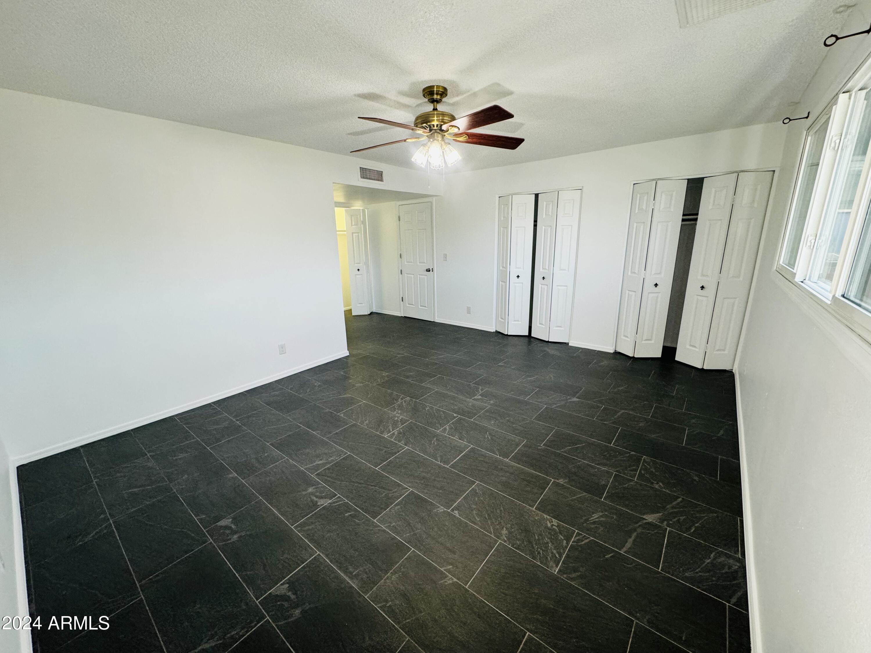 1216 East Riviera Drive Tempe, AZ 85282 - Photo 14 of 33 a view of a livingroom with a ceiling fan and window