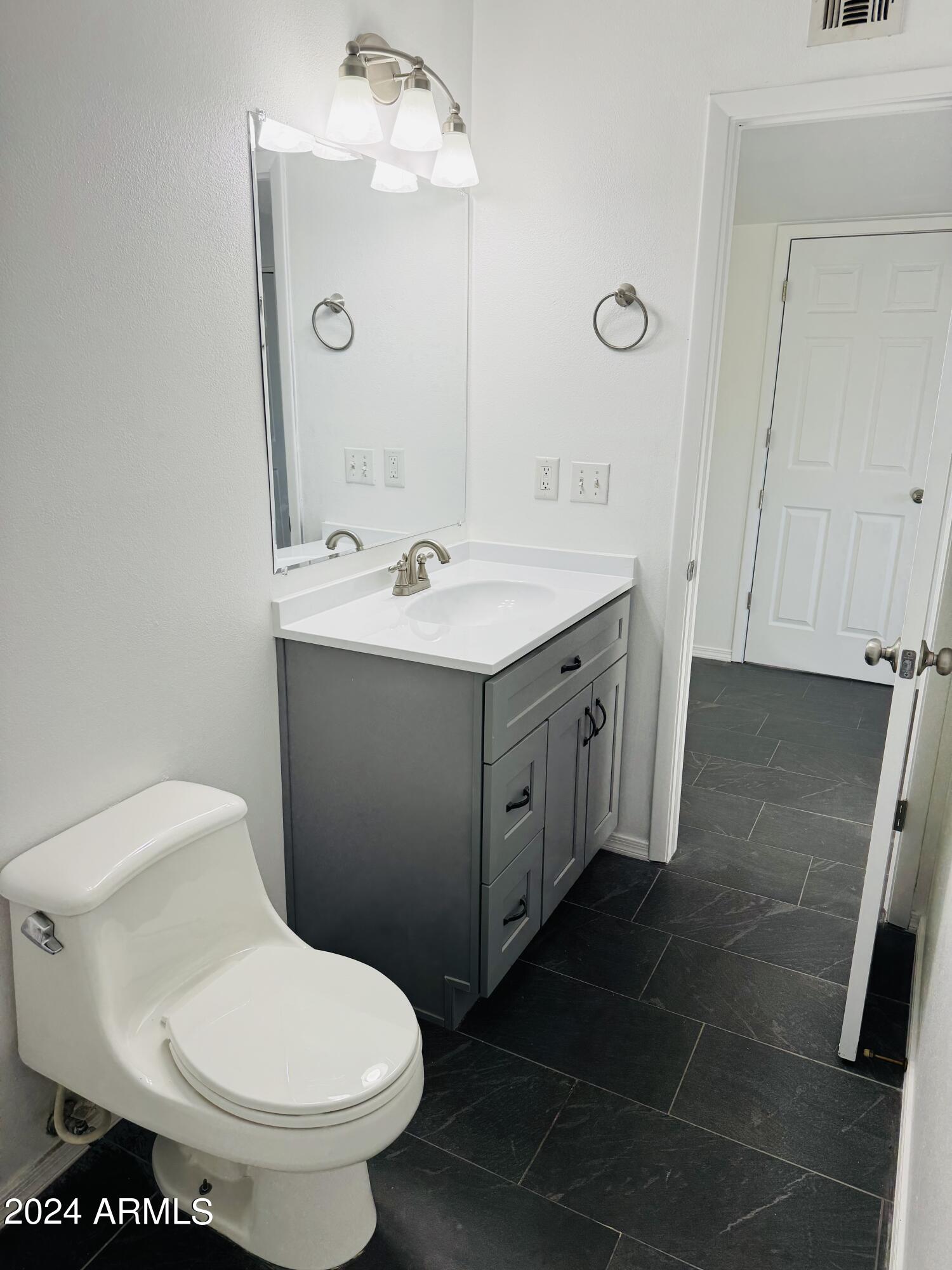 1216 East Riviera Drive Tempe, AZ 85282 - Photo 18 of 33 a bathroom with a toilet sink and mirror