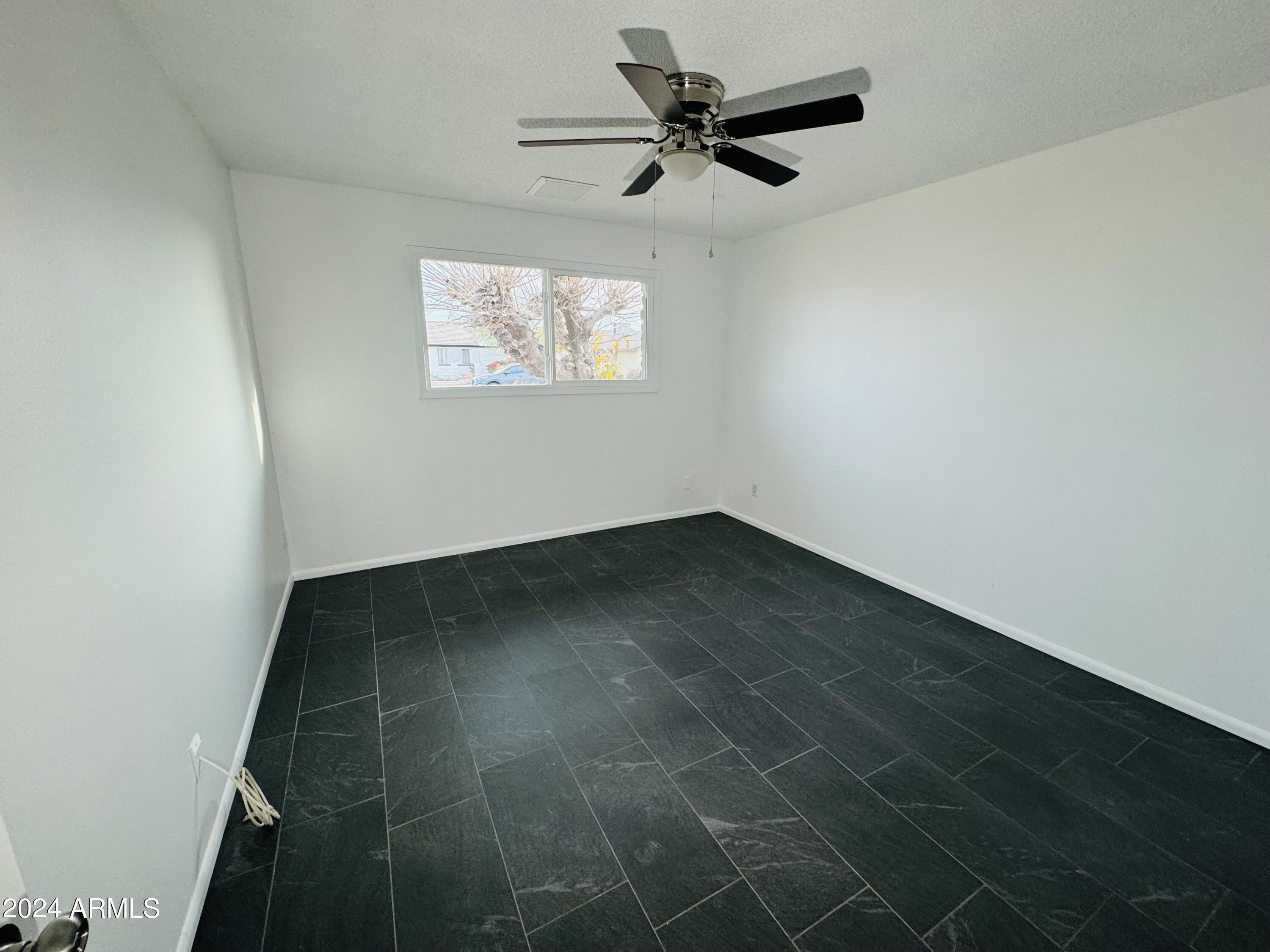 1216 East Riviera Drive Tempe, AZ 85282 - Photo 21 of 33 an empty room with a window