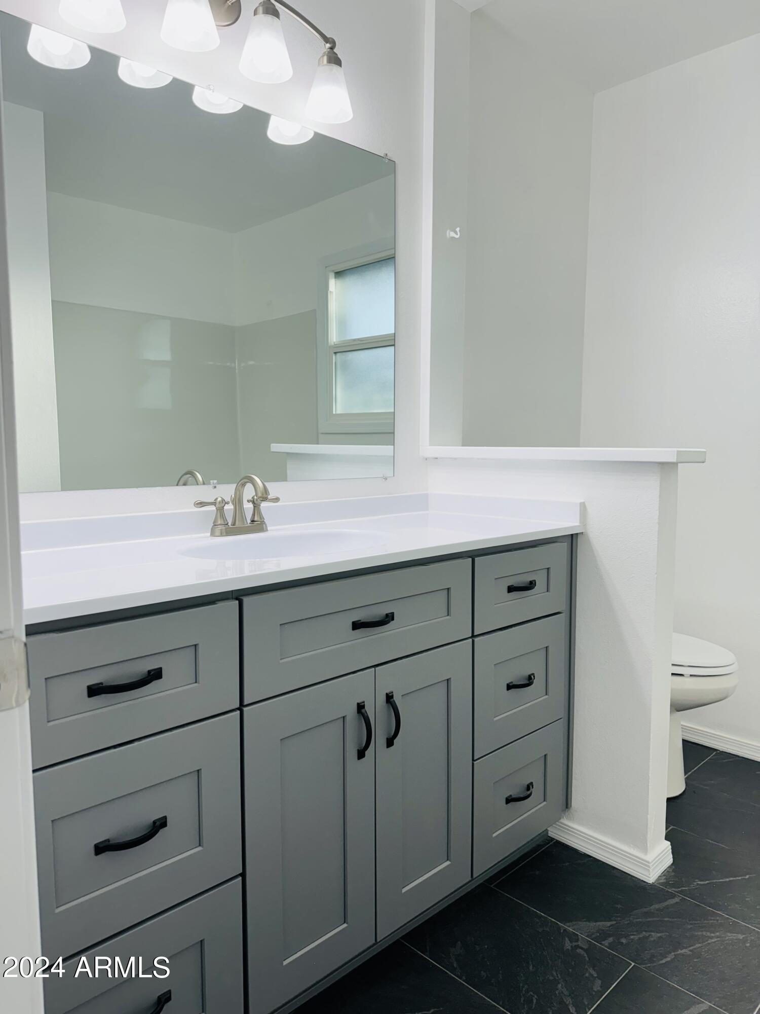 1216 East Riviera Drive Tempe, AZ 85282 - Photo 23 of 33 a bathroom with a sink vanity and mirror