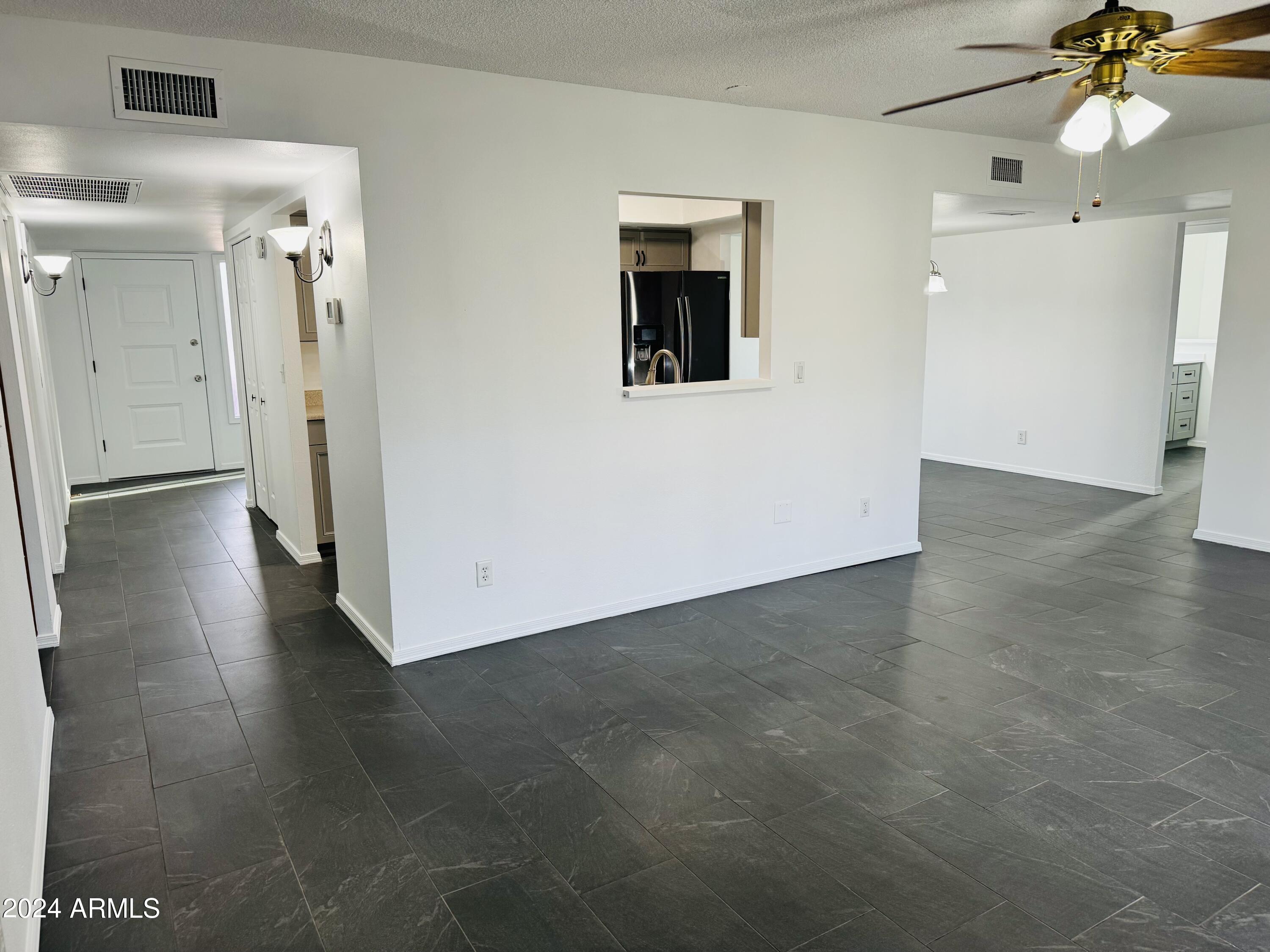 1216 East Riviera Drive Tempe, AZ 85282 - Photo 6 of 33 wooden floor in an empty room with a window