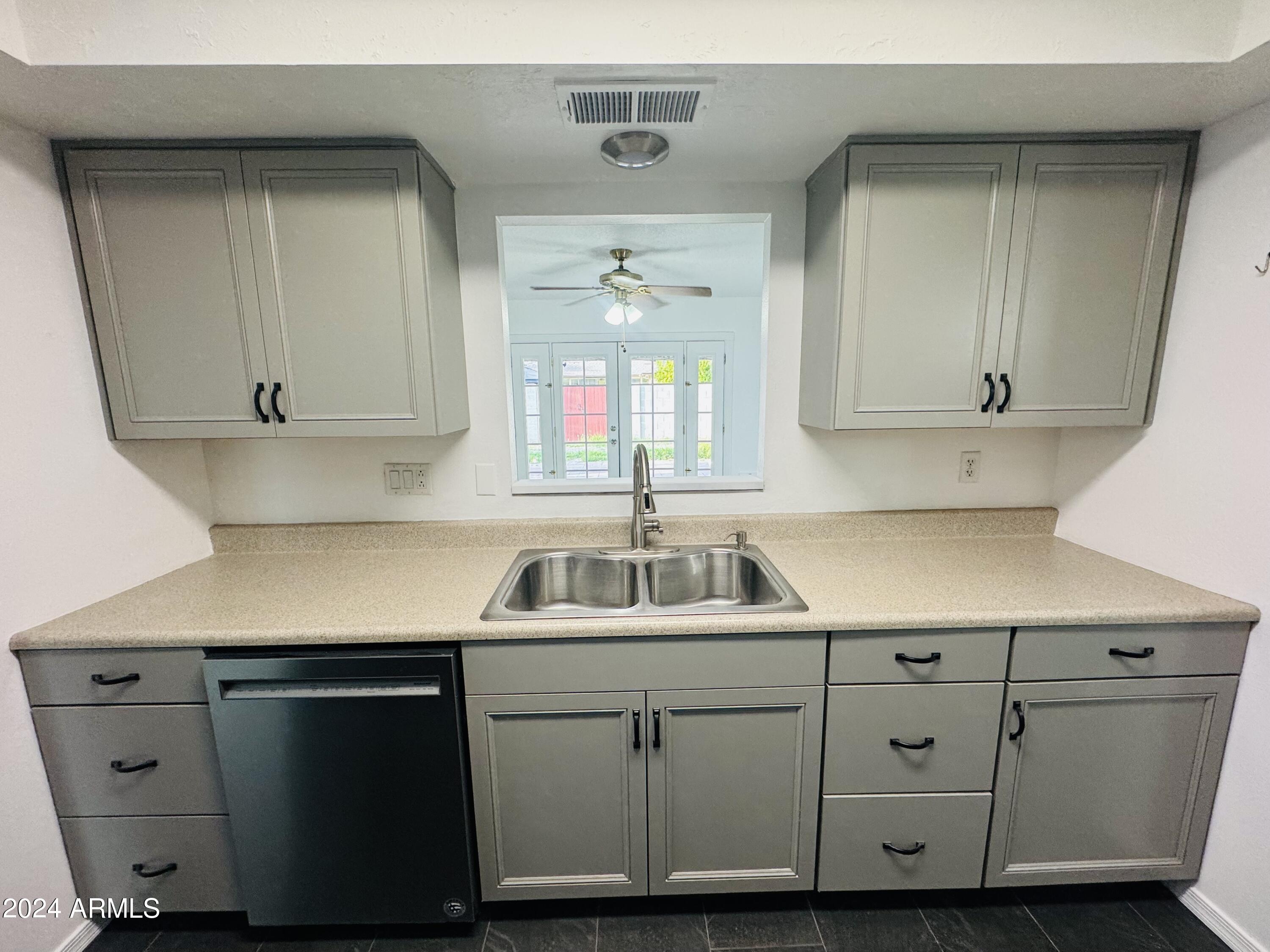 1216 East Riviera Drive Tempe, AZ 85282 - Photo 8 of 33 a kitchen with cabinets appliances and a sink