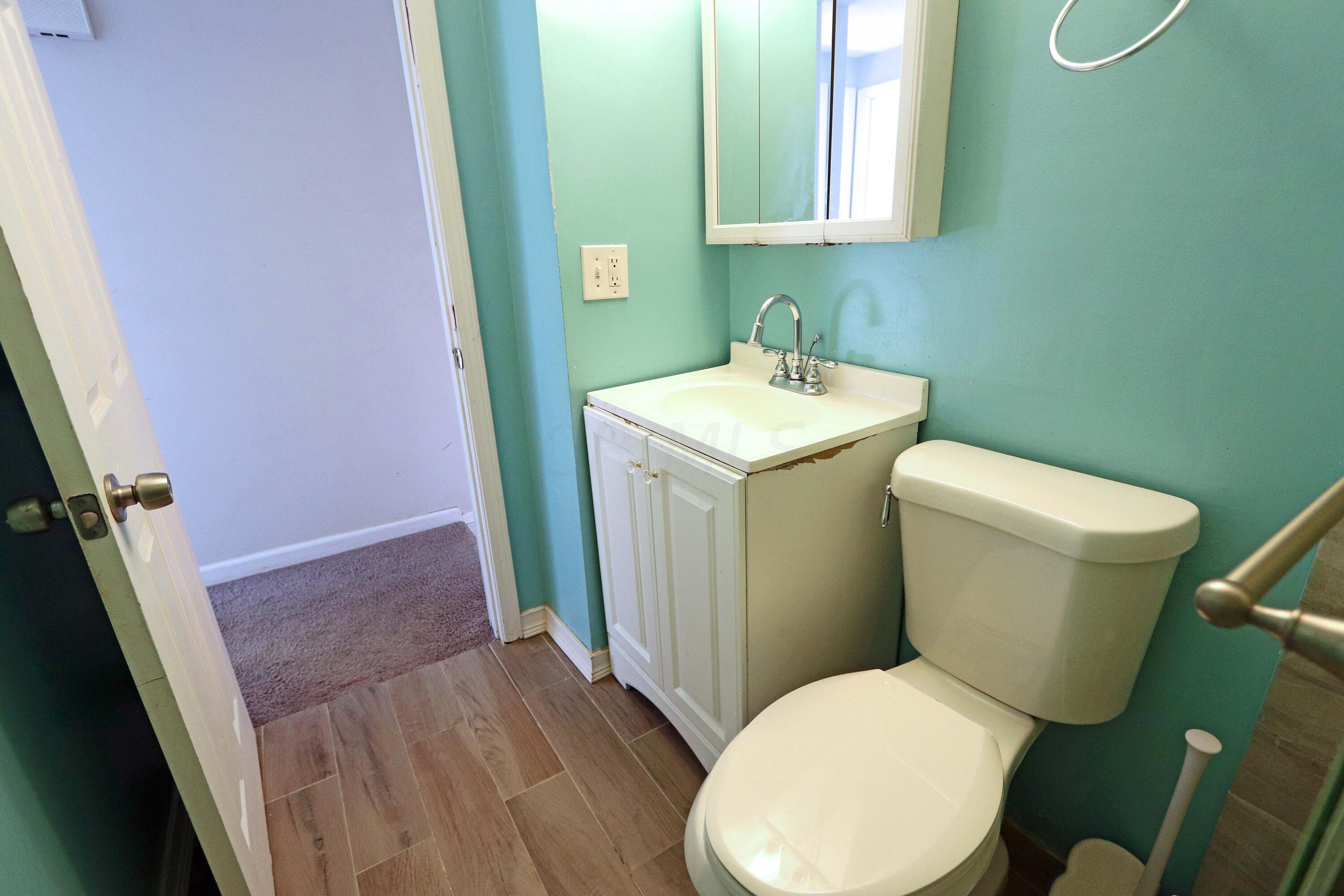4569 Stonehedge Road Columbus, OH 43231 - Photo 24 of 38 White vanity/sink, wall cabinet