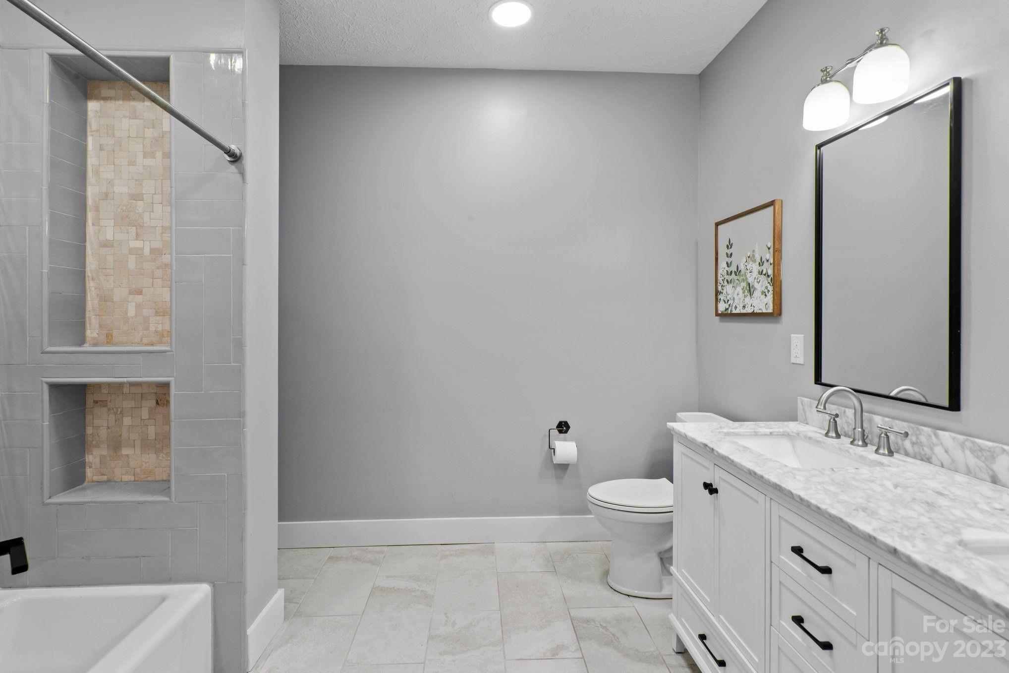 1807 David Drive Shelby, NC 28150 - Photo 18 of 37 a bathroom with a granite countertop sink a toilet and a mirror