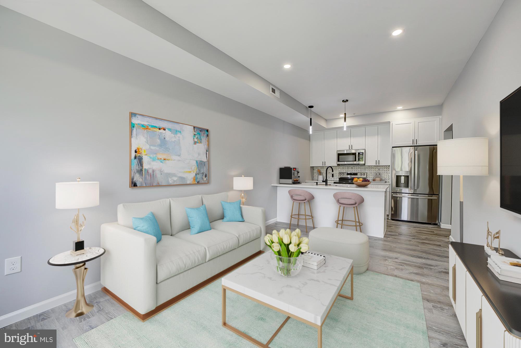 a living room with furniture and kitchen view