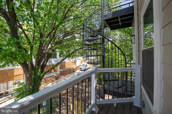 a view of trees and deck in the back