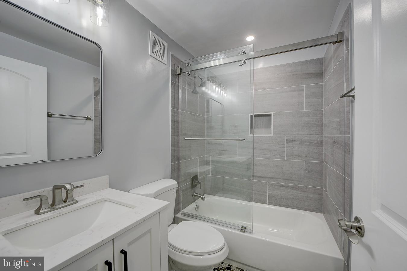 832 19th Street Northeast, Unit B Washington, DC 20002 - Photo 20 of 21 a bathroom with a bathtub shower sink vanity and toilet