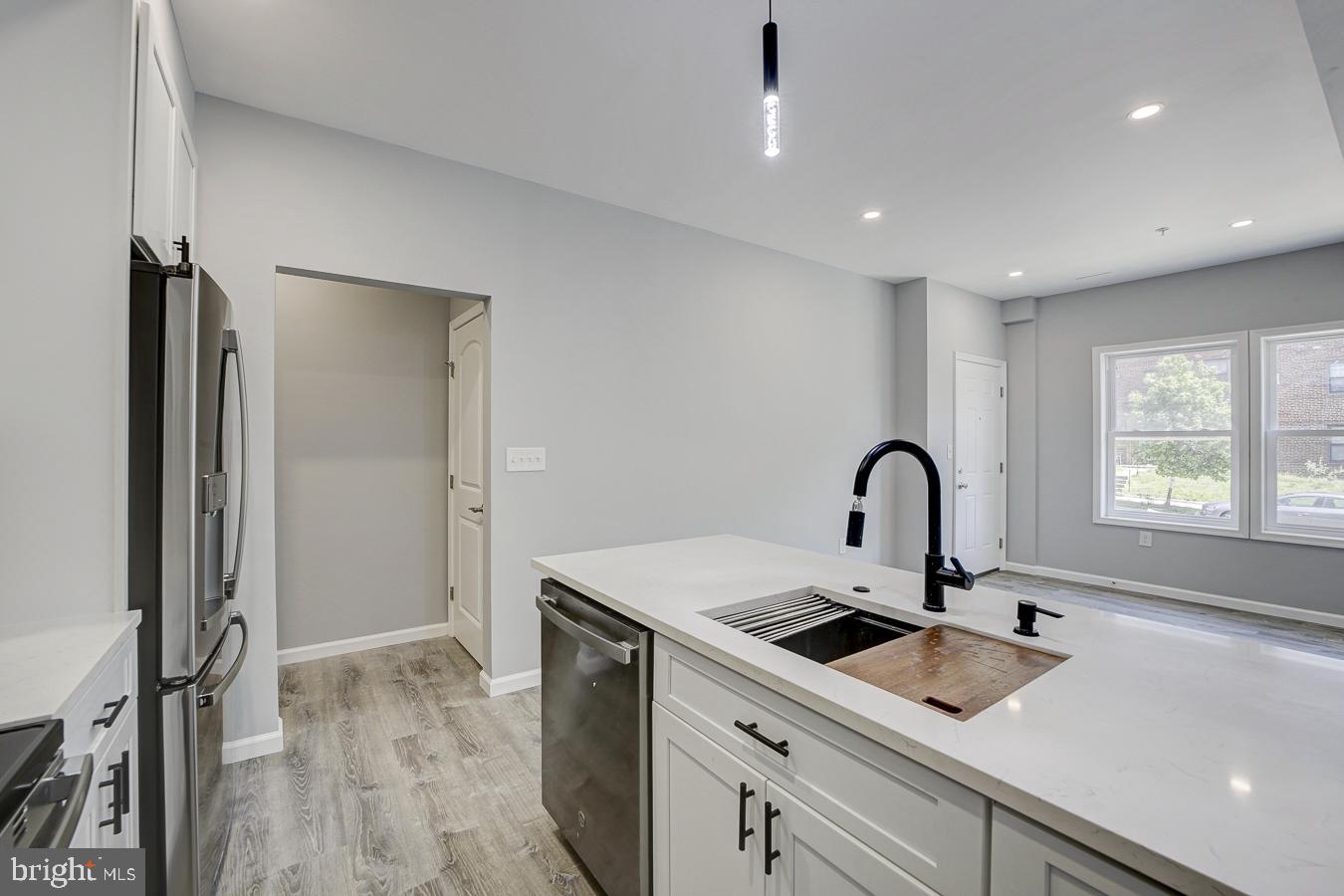 832 19th Street Northeast, Unit B Washington, DC 20002 - Photo 7 of 21 a kitchen with a sink a counter top space and stainless steel appliances