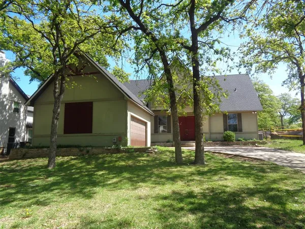 a backyard of a house with table and chairs