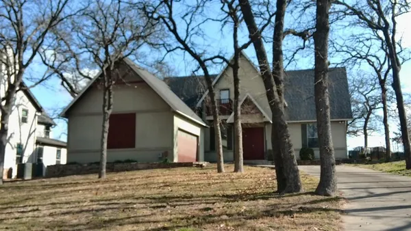 a house that has a tree in front of it