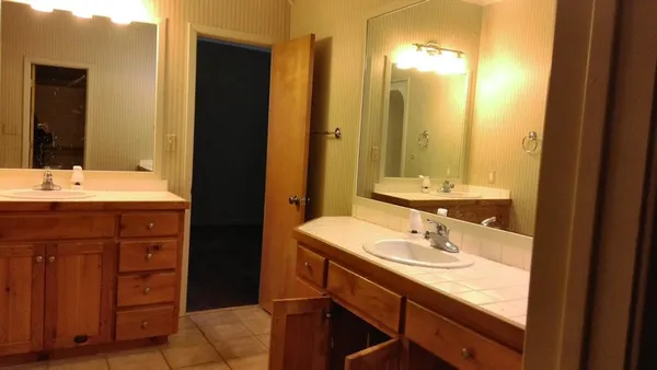 a bathroom with a sink vanity and a mirror