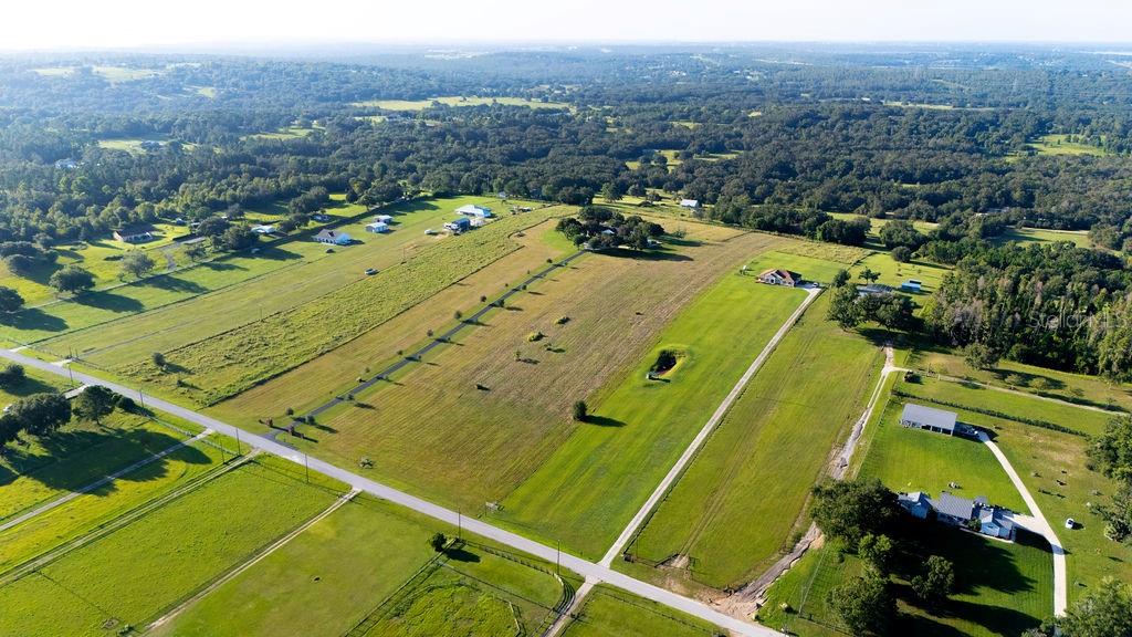 12066 Bruce Hunt Road Clermont, FL 34715 - Photo 16 of 18 a view of a tennis ground and a mountain view