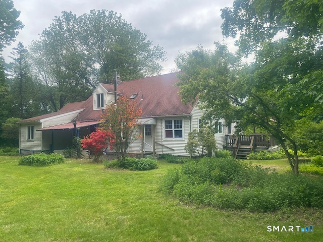 33 Flanders Road Bethlehem, CT 06751 - Photo 3 of 18 a backyard of a house with table and chairs