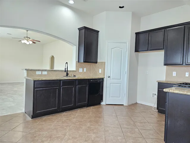 a spacious bathroom with a granite countertop sink and a mirror