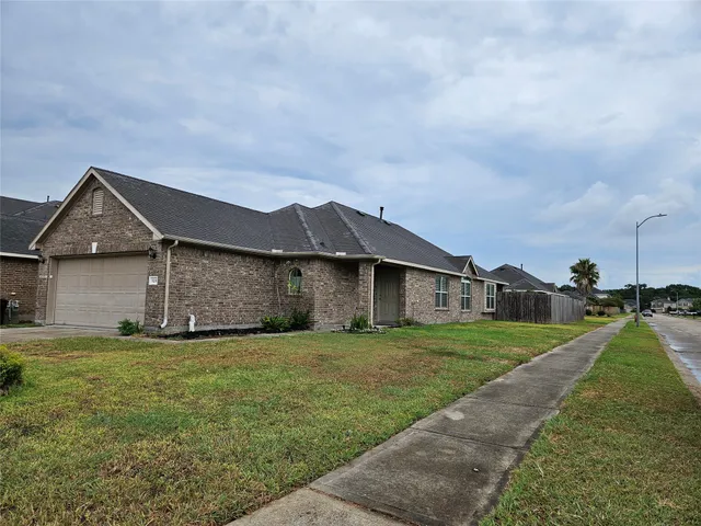 a big house with a big yard and more large trees