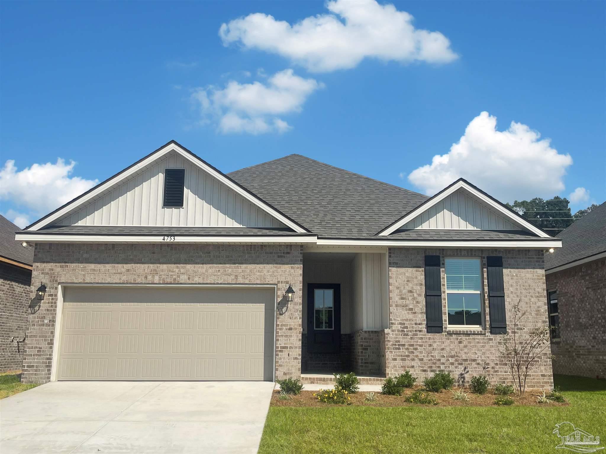 4753 Sago Palm Circle Pace, FL 32571 - Photo 1 of 24 a front view of a house with garden