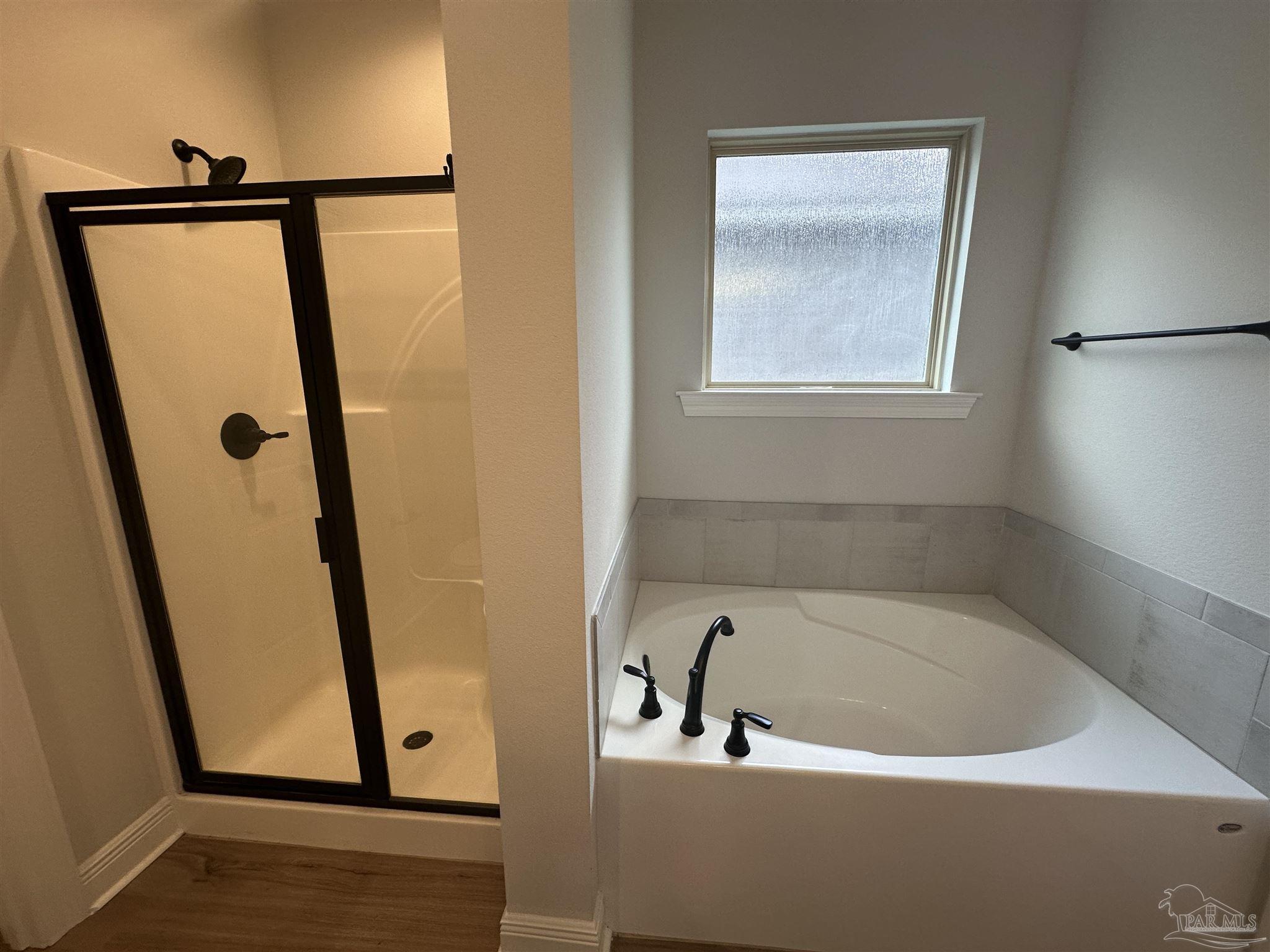 4753 Sago Palm Circle Pace, FL 32571 - Photo 12 of 24 a bathroom with a bathtub