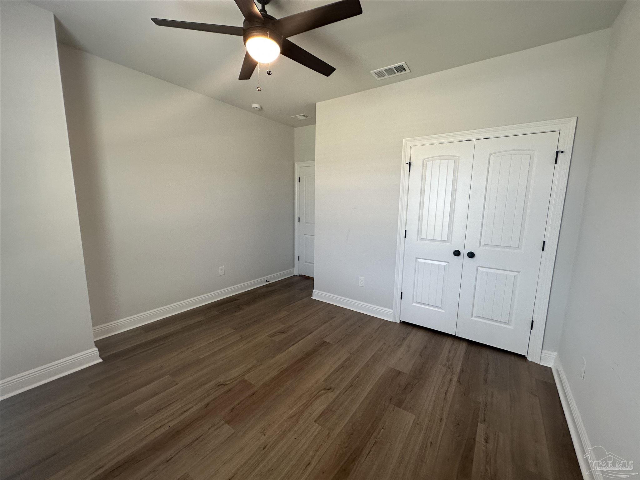 4753 Sago Palm Circle Pace, FL 32571 - Photo 16 of 24 a view of an empty room with wooden floor