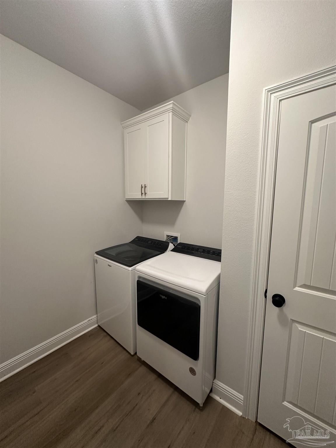 4753 Sago Palm Circle Pace, FL 32571 - Photo 22 of 24 a view of washer and dryer with wooden floor