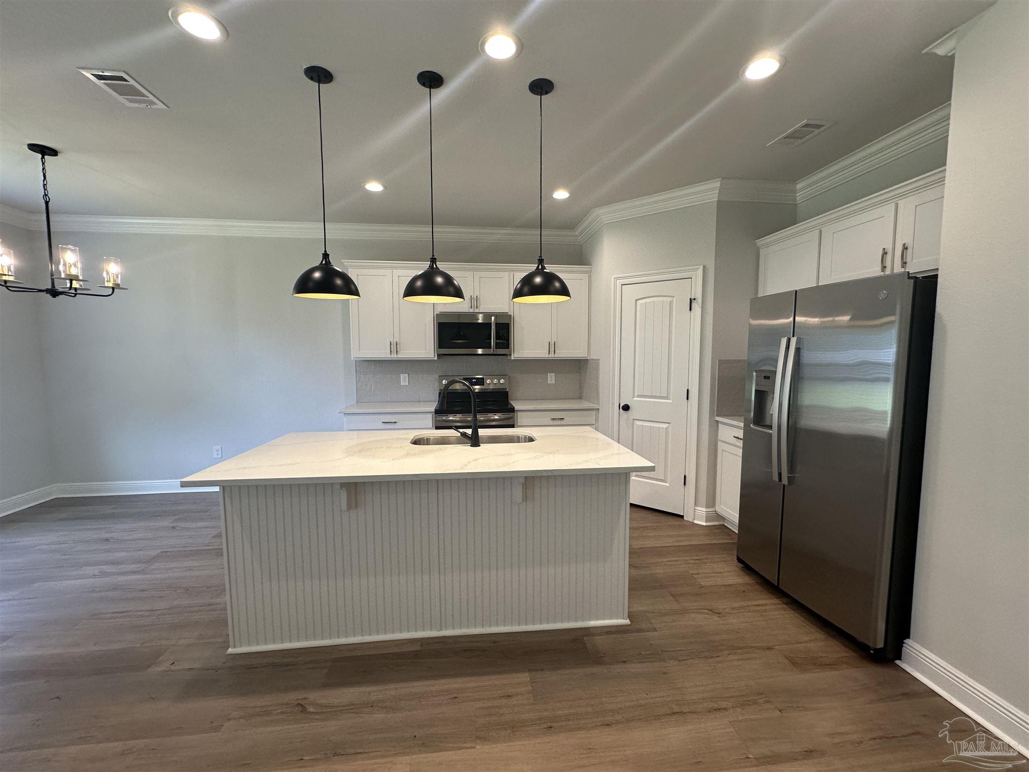 4753 Sago Palm Circle Pace, FL 32571 - Photo 4 of 24 a view kitchen with a appliances and wooden floor