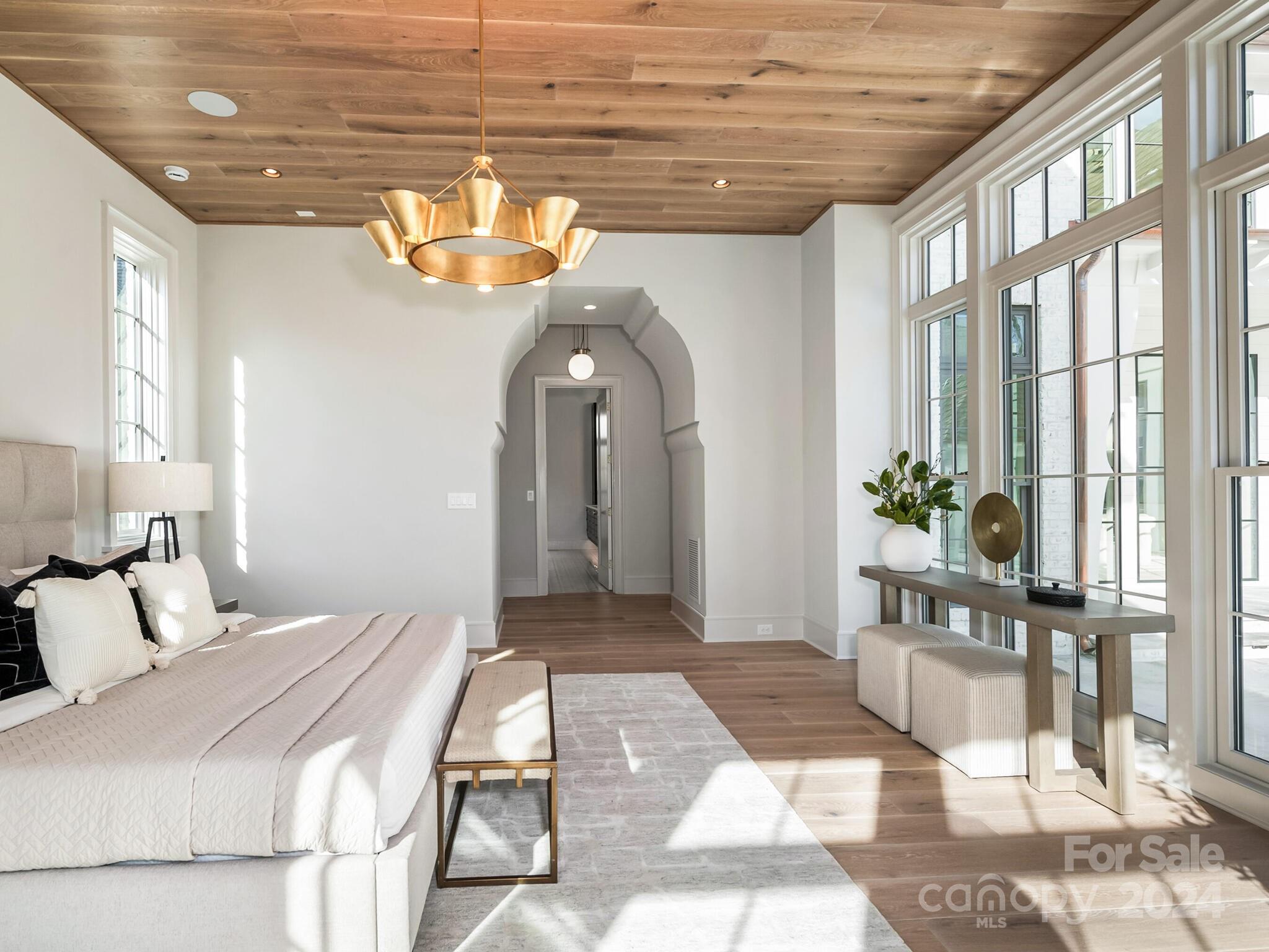 2215 Ferncliff Road Charlotte, NC 28211 - Photo 24 of 46 a bedroom with a bed and a chandelier