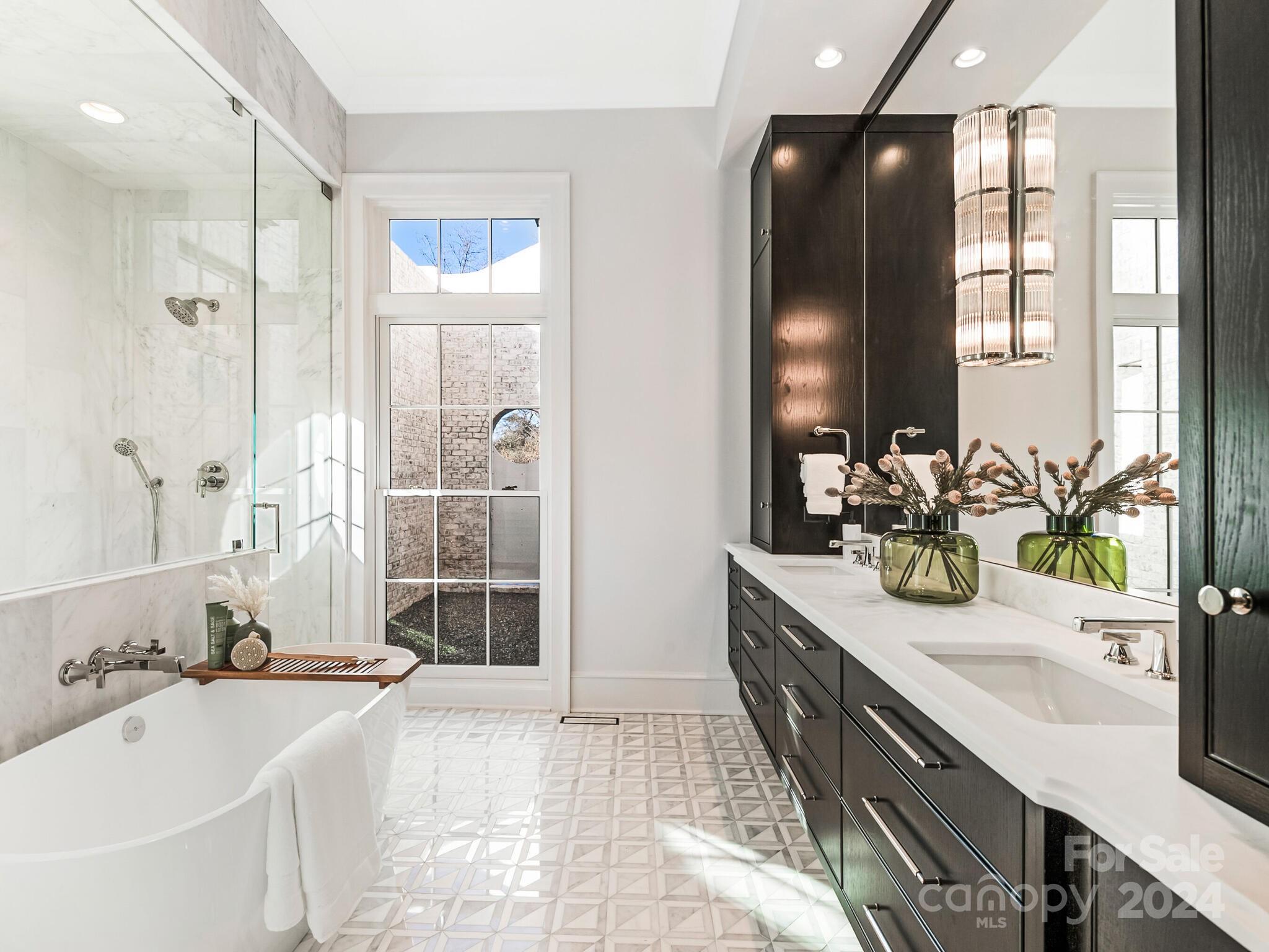 2215 Ferncliff Road Charlotte, NC 28211 - Photo 25 of 46 a bathroom with a tub sink and mirror