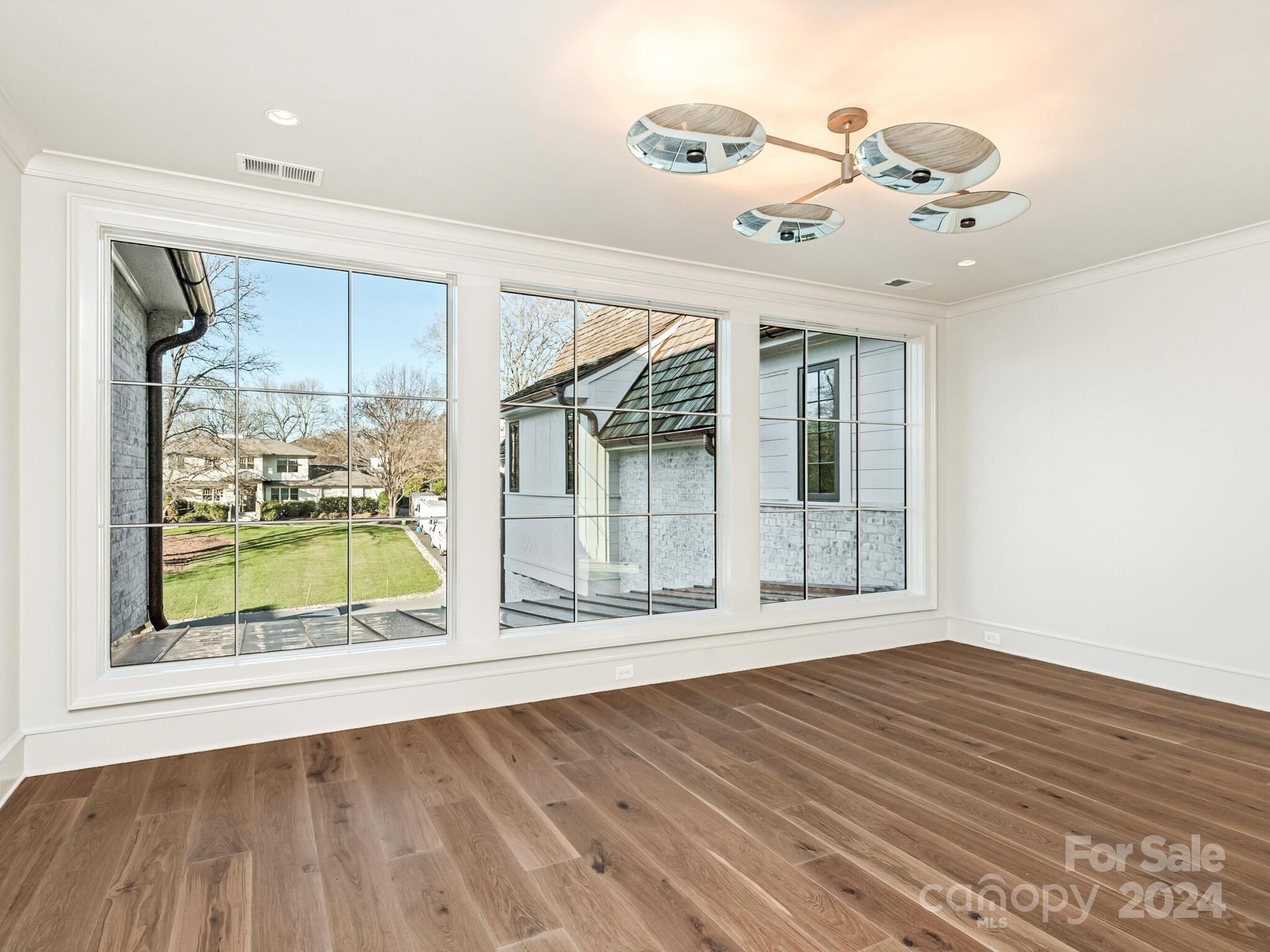 2215 Ferncliff Road Charlotte, NC 28211 - Photo 30 of 46 a view of an empty room with wooden floor and a window