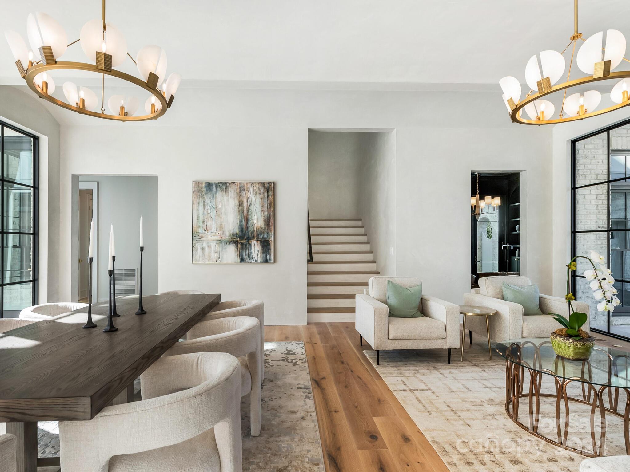 2215 Ferncliff Road Charlotte, NC 28211 - Photo 3 of 46 a living room with furniture a chandelier a mirror and a large window