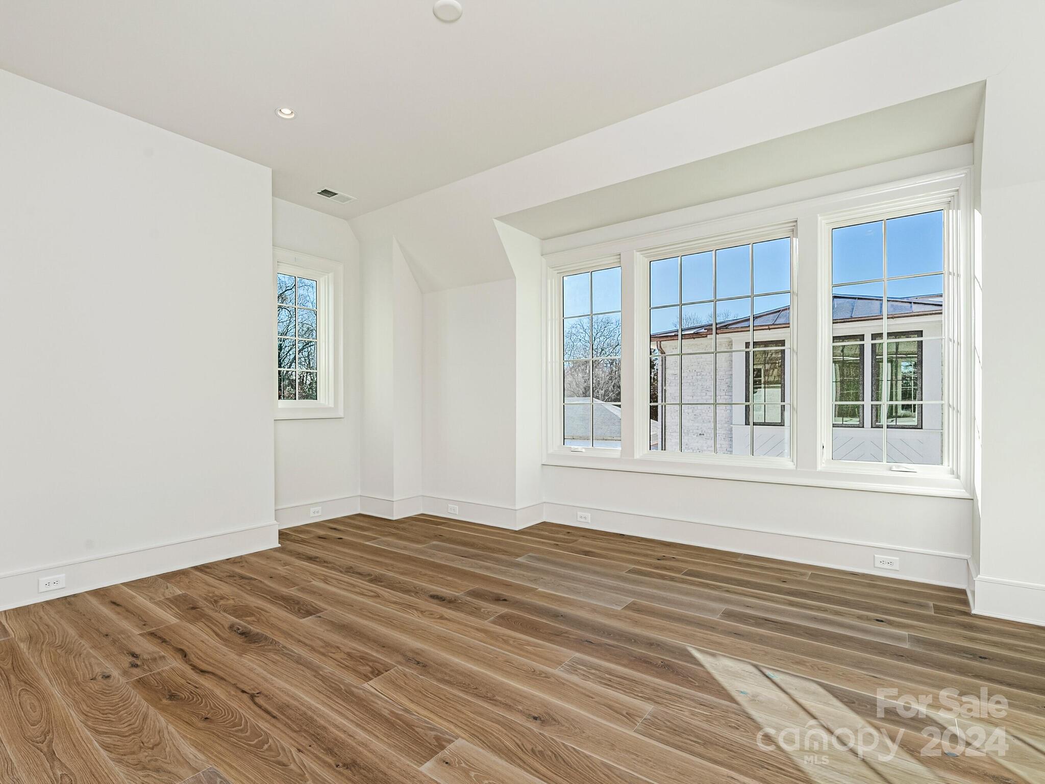 2215 Ferncliff Road Charlotte, NC 28211 - Photo 31 of 46 a view of empty room with wooden floor and fan