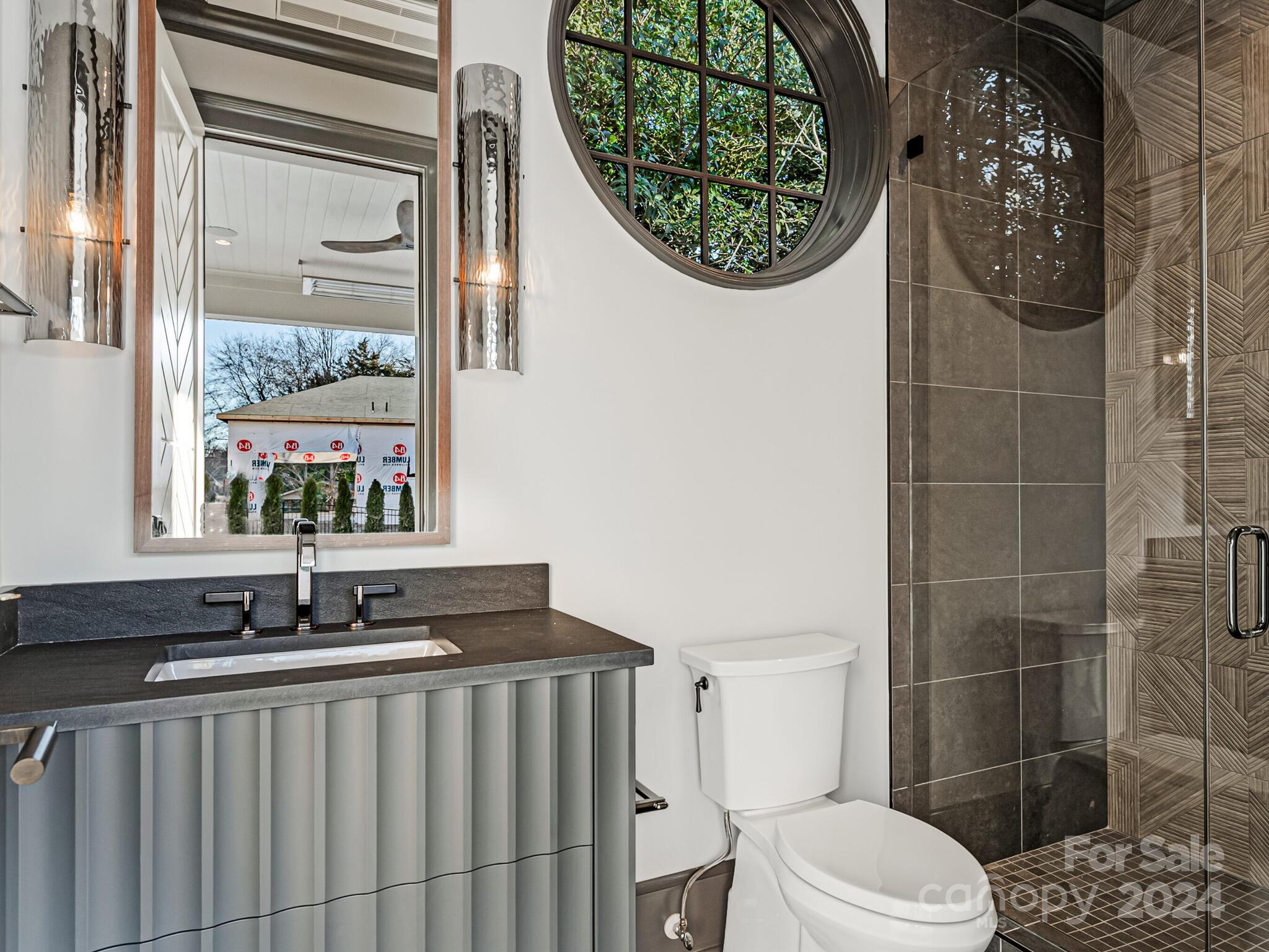 2215 Ferncliff Road Charlotte, NC 28211 - Photo 44 of 46 a bathroom with a toilet a sink and mirror