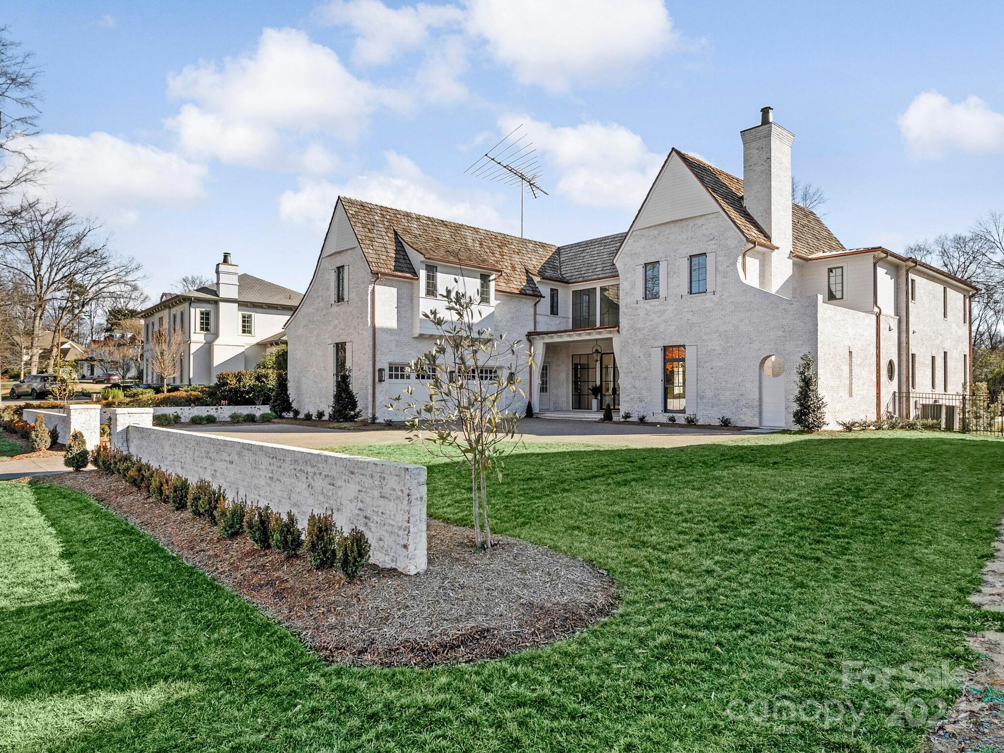 2215 Ferncliff Road Charlotte, NC 28211 - Photo 46 of 46 a view of a white house next to a yard with big trees