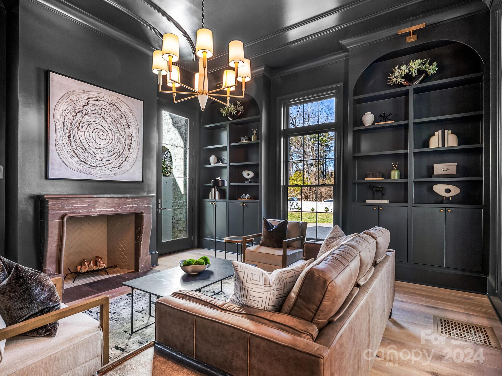 2215 Ferncliff Road Charlotte, NC 28211 - Photo 6 of 46 a living room with furniture a chandelier and a fireplace