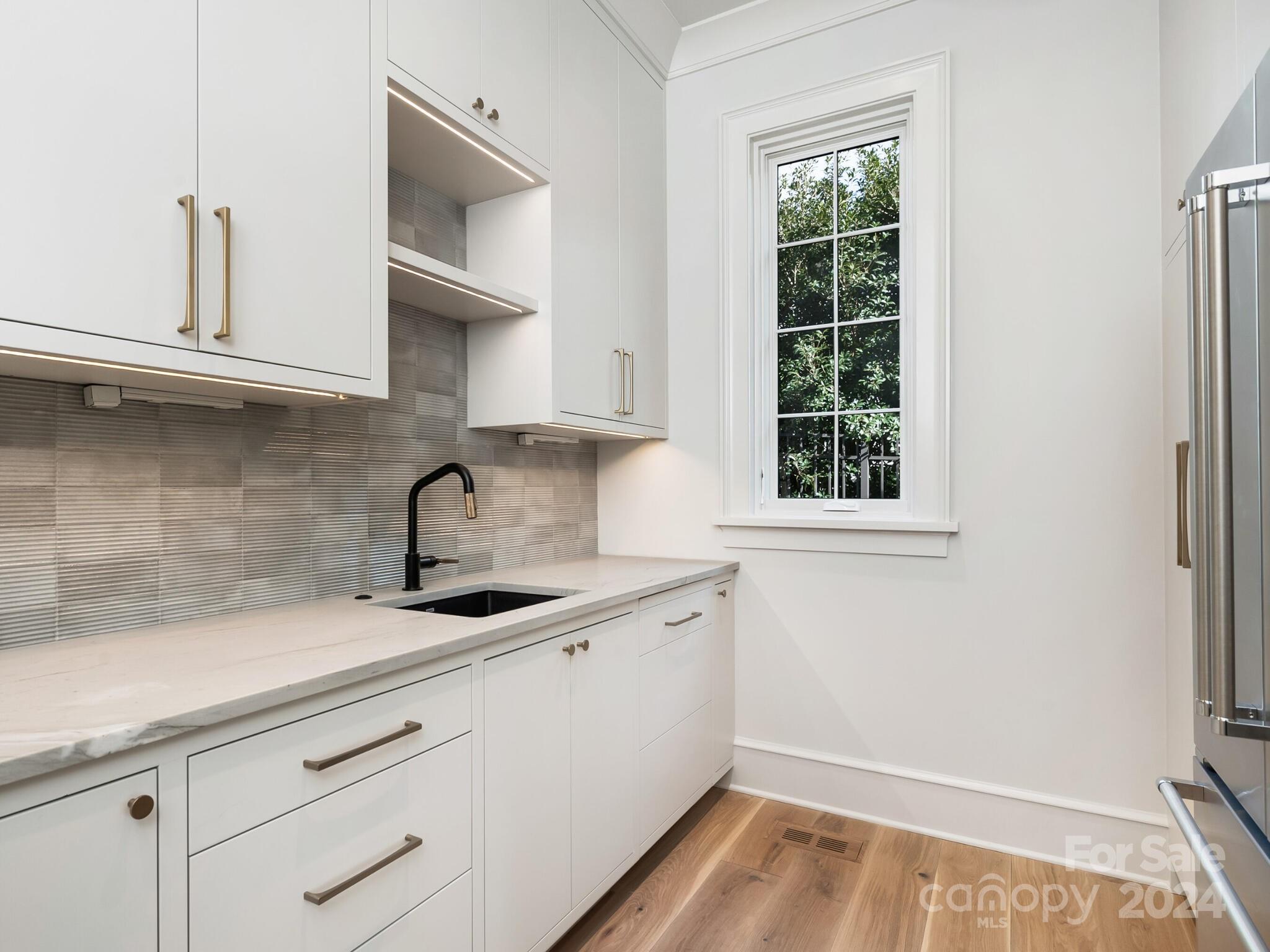 2215 Ferncliff Road Charlotte, NC 28211 - Photo 8 of 46 a kitchen with a sink and cabinets