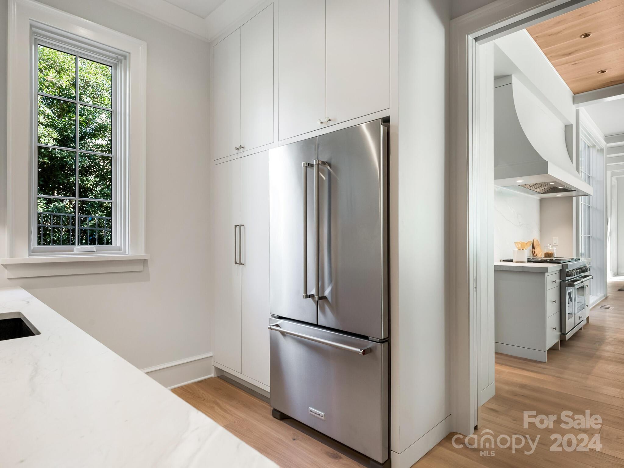 2215 Ferncliff Road Charlotte, NC 28211 - Photo 9 of 46 a metallic refrigerator freezer sitting in a kitchen